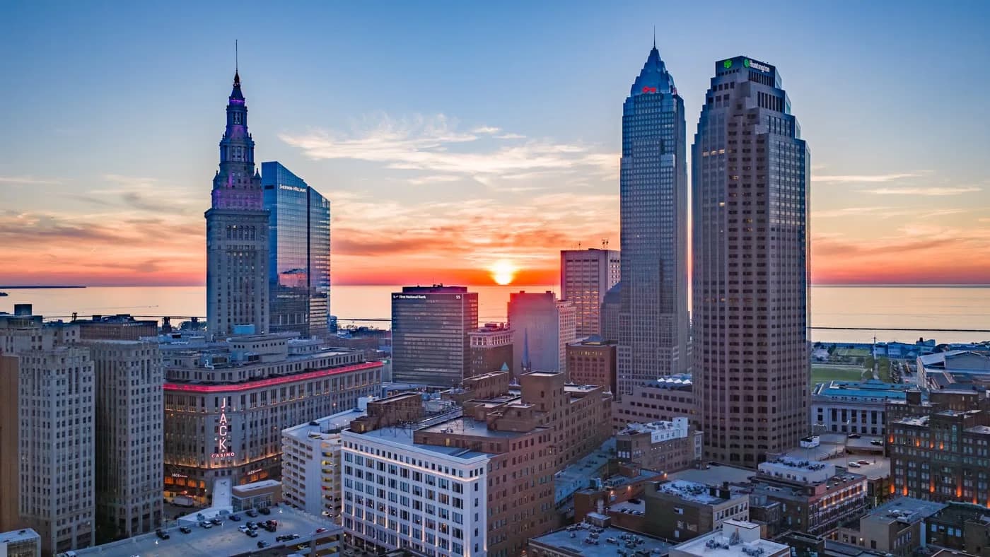 The Cleveland, Ohio skyline at sunset, photographed from the air over Lake Erie.